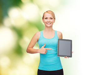 Image showing sporty woman with tablet pc blank screen