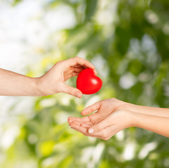 Image showing man hand giving red heart to woman