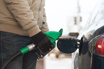 Image showing close up of male refilling car fuel tank