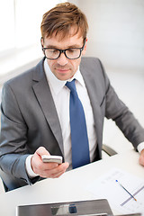 Image showing businessman working with laptop and smartphone