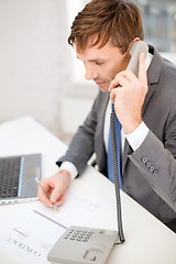 Image showing businessman with laptop computer and phone