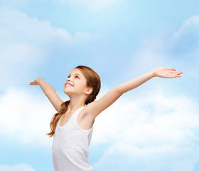 Image showing smiling teenage girl with raised hands