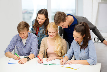 Image showing smiling students with notebooks at school