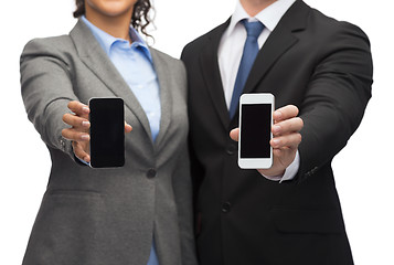 Image showing businessman and businesswoman with smartphones