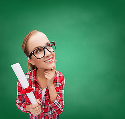 Image showing smiling woman in black eyeglasses with diploma