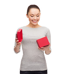 Image showing beautiful girl opening red gift box