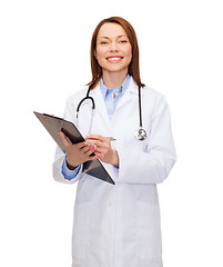Image showing smiling female doctor with clipboard