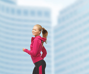 Image showing sporty woman running or jumping