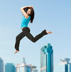 Image showing sporty woman jumping in sportswear