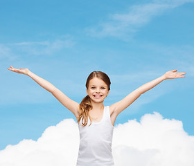 Image showing smiling teenage girl with raised hands