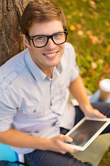 Image showing smiling male student in eyeglasses with tablet pc