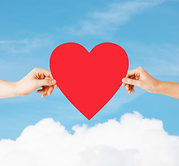 Image showing couple hands holding red heart
