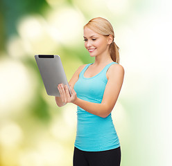 Image showing sporty woman with tablet pc