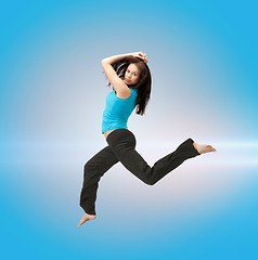 Image showing sporty woman jumping in sportswear