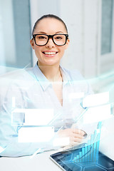 Image showing smiling businesswoman in eyeglasses with tablet pc