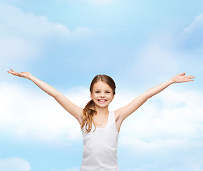 Image showing smiling teenage girl with raised hands