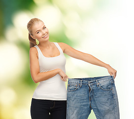 Image showing sporty woman showing big pants