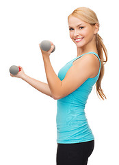 Image showing young sporty woman with light dumbbells