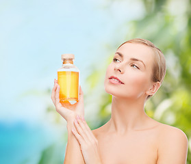 Image showing lovely woman with oil bottle