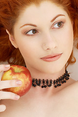Image showing lovely redhead with delicious apple
