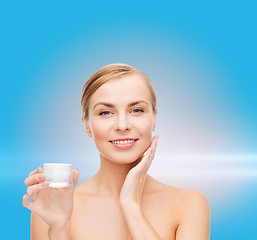 Image showing woman applying cream on her skin