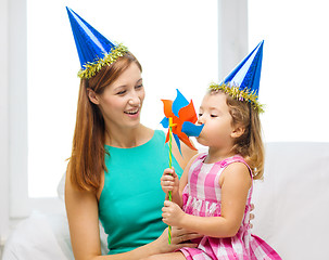 Image showing mother and daughter in blue hats with pinwheel