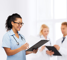 Image showing smiling female african american doctor or nurse