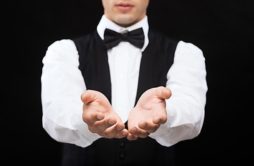 Image showing dealer holding something on palms of his hands