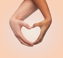 Image showing woman and man hands showing heart shape