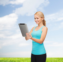 Image showing sporty woman with tablet pc