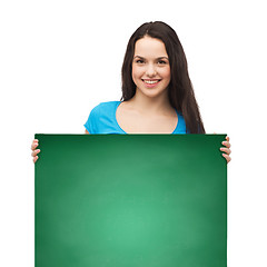 Image showing smiling young girl with blank white board