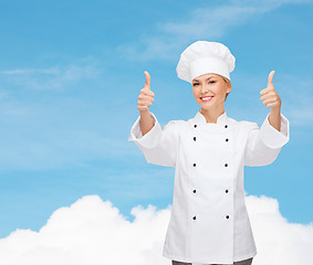 Image showing smiling female chef showing thumbs up