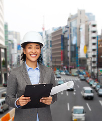 Image showing businesswoman in white helmet with clipboard