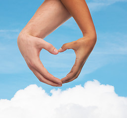 Image showing woman and man hands showing heart shape