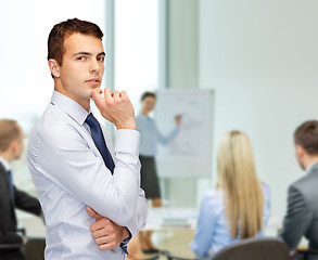 Image showing pensive young buisnessman at office