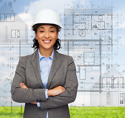 Image showing businesswoman in white helmet with crossed arms