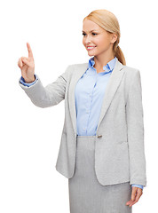 Image showing smiling businesswoman working with virtual screen