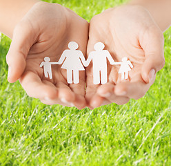 Image showing female hands with paper man family