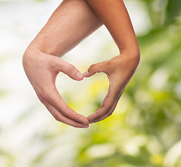 Image showing woman and man hands showing heart shape