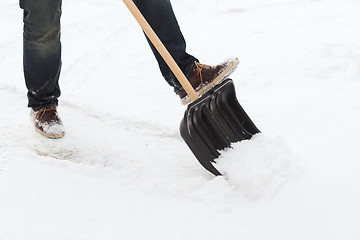 Image showing closeup of man shoveling snow from driveway