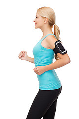 Image showing sporty woman running with smartphone