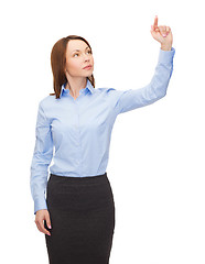 Image showing calm businesswoman working with virtual screen