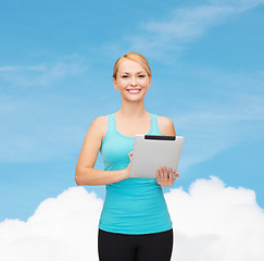 Image showing sporty woman with tablet pc