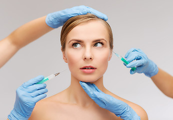 Image showing woman face and beautician hands with syringe