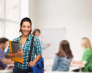 Image showing smiling student with folders, tablet pc and bag