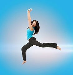 Image showing sporty woman jumping in sportswear