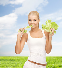 Image showing woman biting lettuce