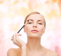 Image showing beautiful woman with makeup brush