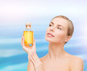 Image showing lovely woman with oil bottle