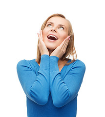 Image showing amazed laughing young woman